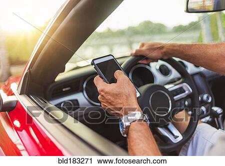 Caucasian man using cell phone and driving convertible View Large Photo Image Stock Image - Caucasian man using cell phone and driving convertible. Fotosearch