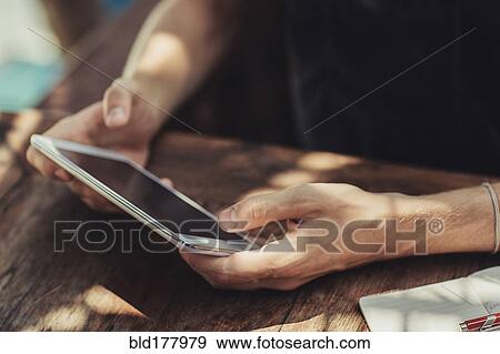 Caucasian man using cell phone at table View Large Photo Image Stock Photo - Caucasian man using cell phone at table. Fotosearch