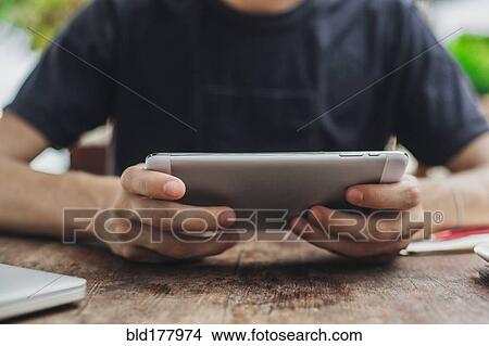 Caucasian man using cell phone in cafe View Large Photo Image Picture - Caucasian man using cell phone in cafe. Fotosearch