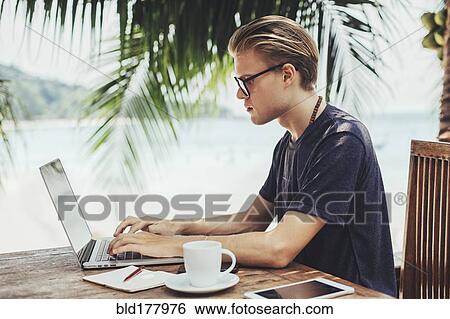 Caucasian man using laptop in cafe View Large Photo Image Stock Photograph - Caucasian man using laptop in cafe. Fotosearch