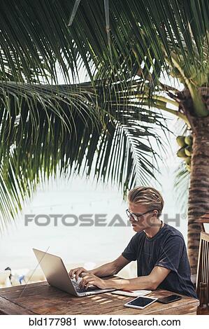 Caucasian man using laptop outdoors View Large Photo Image Stock Image - Caucasian man using laptop outdoors. Fotosearch