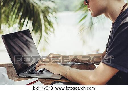 Caucasian man using laptop outdoors View Large Photo Image Stock Photo - Caucasian man using laptop outdoors. Fotosearch