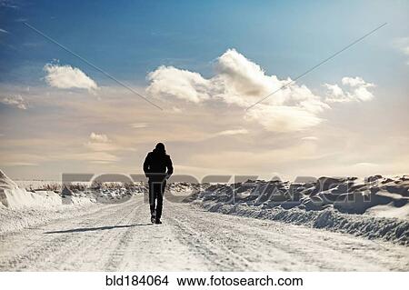 Caucasian man walking in snowy landscape View Large Photo Image Picture - Caucasian man walking in snowy landscape. Fotosearch