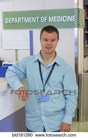 Caucasian man with Down Syndrome working in hospital View Large Photo Image Stock Image - Caucasian man with Down Syndrome working in hospital. Fotosearch