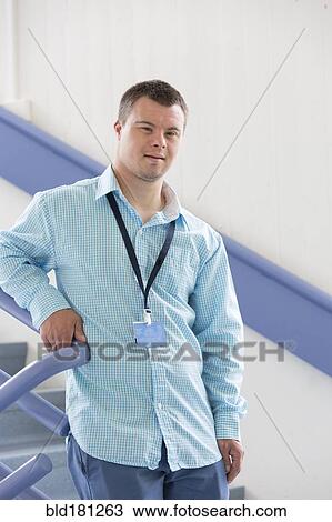 Caucasian man with Down Syndrome wearing badge on stairs View Large Photo Image Stock Image - Caucasian man with Down Syndrome wearing badge on stairs. Fotosearch
