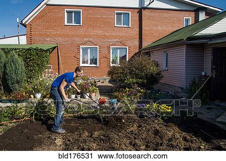 Caucasian man working in garden View Large Photo Image Stock Image - Caucasian man working in garden. Fotosearch