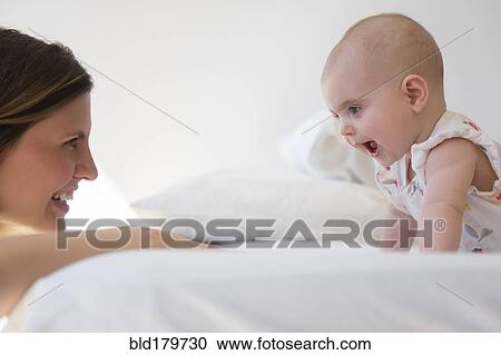 Caucasian mother and baby daughter playing View Large Photo Image Stock Image - Caucasian mother and baby daughter playing. Fotosearch