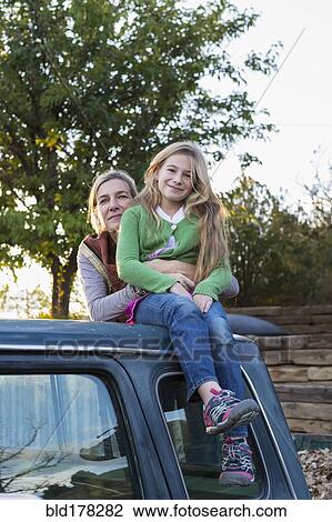Caucasian mother and daughter hugging on truck roof View Large Photo Image Stock Image - Caucasian mother and daughter hugging on truck roof. Fotosearch