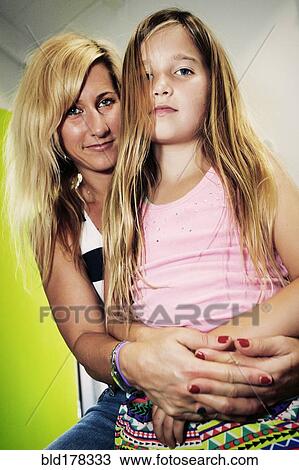 Stock Image - Caucasian mother and daughter hugging. Fotosearch