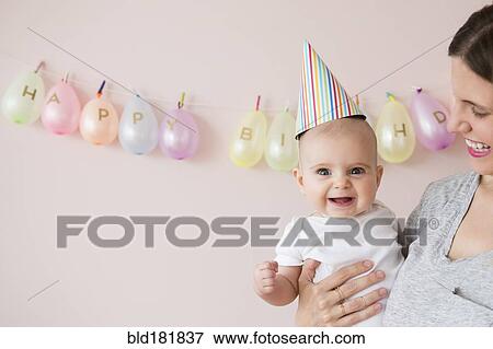 Stock Photo - Caucasian mother and daughter celebrating birthday. Fotosearch