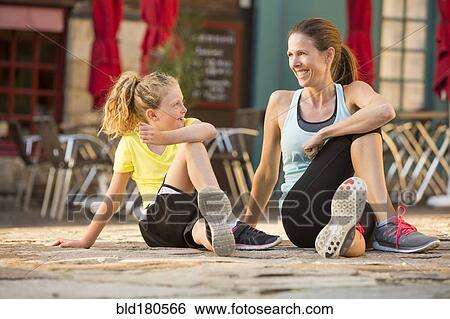 Caucasian mother and daughter stretching outdoors View Large Photo Image Stock Photograph - Caucasian mother and daughter stretching outdoors. Fotosearch
