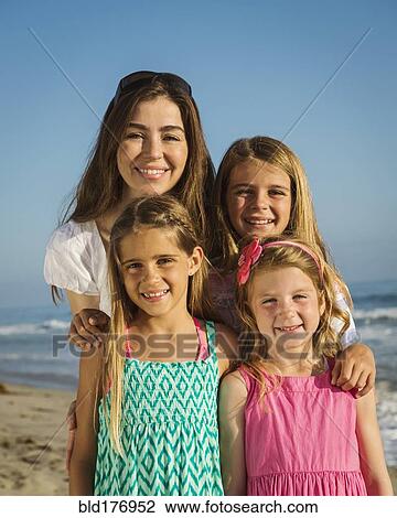 Caucasian mother and daughters smiling on beach View Large Photo Image Stock Image - Caucasian mother and daughters smiling on beach. Fotosearch