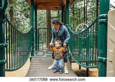 Caucasian mother and son playing on playground View Large Photo Image Stock Photo - Caucasian mother and son playing on playground. Fotosearch