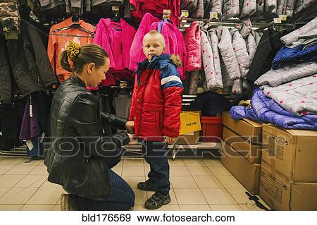 Stock Photo - Caucasian mother and son shopping in store. Fotosearch