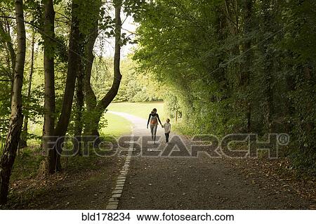 Caucasian mother and son walking in park View Large Photo Image Picture - Caucasian mother and son walking in park. Fotosearch