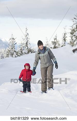 Caucasian mother and son walking in snow View Large Photo Image Stock Photo - Caucasian mother and son walking in snow. Fotosearch