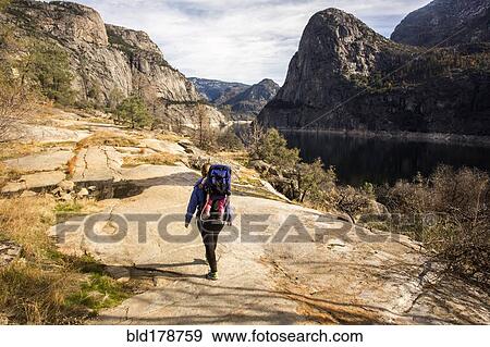 Stock Photo - "Caucasian mother carrying daughter in Yosemite National Park, California, United States". Fotosearch