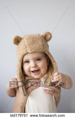 Caucasian mother holding baby daughter in fuzzy hat View Large Photo Image Stock Image - Caucasian mother holding baby daughter in fuzzy hat. Fotosearch
