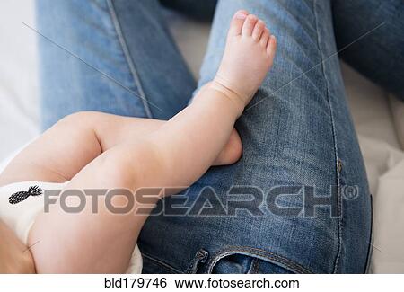 Caucasian mother holding baby daughter View Large Photo Image Stock Photograph - Caucasian mother holding baby daughter. Fotosearch
