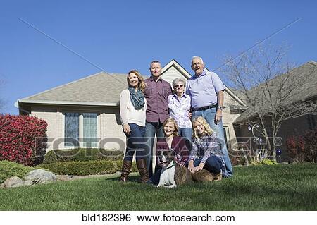 Stock Photograph - Caucasian multi-generation family smiling in yard. Fotosearch