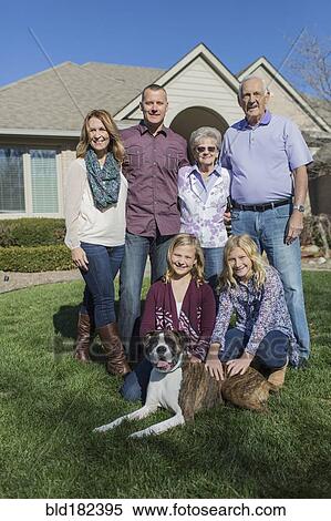 Stock Photography - Caucasian multi-generation family smiling in yard. Fotosearch