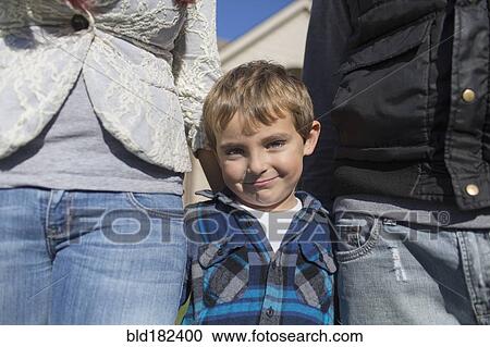 Stock Image - Caucasian parents and son smiling outdoors. Fotosearch