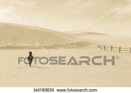 Stock Photography - Caucasian preschooler boy walking in desert. Fotosearch