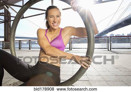 Stock Photo - "Caucasian runner exercising on waterfront, New York, New York, United States". Fotosearch