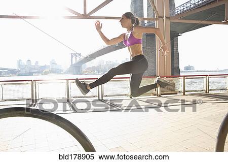 "Caucasian runner jumping on waterfront, New York, New York, United States" View Large Photo Image Stock Photography - "Caucasian runner jumping on waterfront, New York, New York, United States". Fotosearch