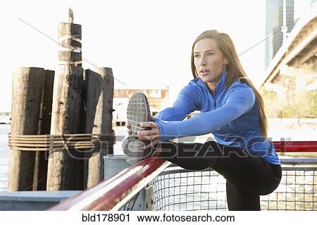 "Caucasian runner stretching on waterfront, New York, New York, United States" View Large Photo Image Stock Image - "Caucasian runner stretching on waterfront, New York, New York, United States". Fotosearch