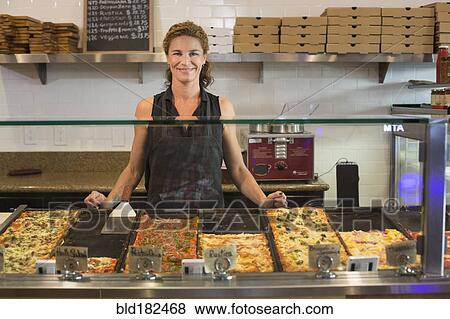 Caucasian server smiling in cafe View Large Photo Image Stock Photo - Caucasian server smiling in cafe. Fotosearch
