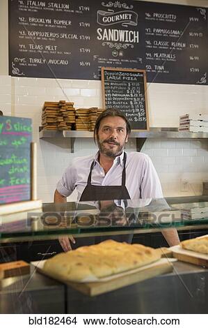 Picture - Caucasian server working in cafe. Fotosearch