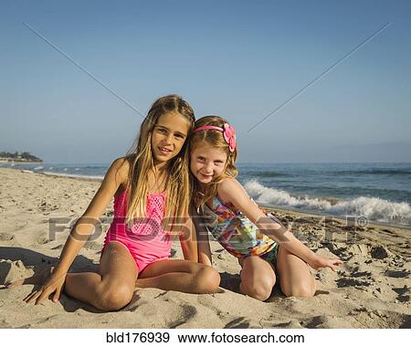Caucasian sisters smiling on beach View Large Photo Image Stock Photo - Caucasian sisters smiling on beach. Fotosearch