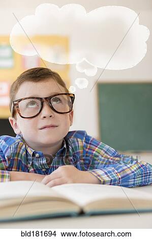 Picture - Caucasian student with thought bubble in classroom. Fotosearch