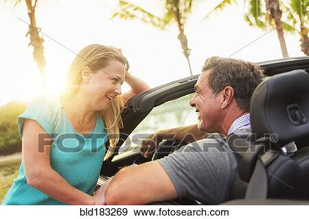 Caucasian talking in convertible View Large Photo Image Stock Photo - Caucasian talking in convertible. Fotosearch