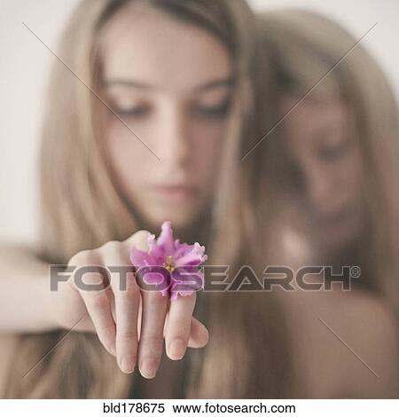 Caucasian teenage girl holding flower View Large Photo Image Stock Photography - Caucasian teenage girl holding flower. Fotosearch