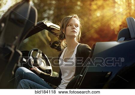 Stock Photo - Caucasian teenage girl sitting in convertible. Fotosearch