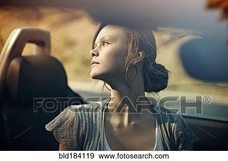 Stock Photo - Caucasian teenage girl sitting in convertible. Fotosearch