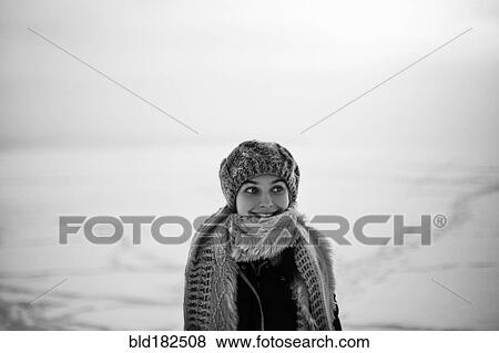 Stock Photo - Caucasian teenage girl wearing scarf in snow. Fotosearch