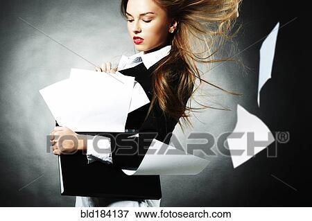 Stock Photo - Caucasian teenage girl with windblown papers. Fotosearch