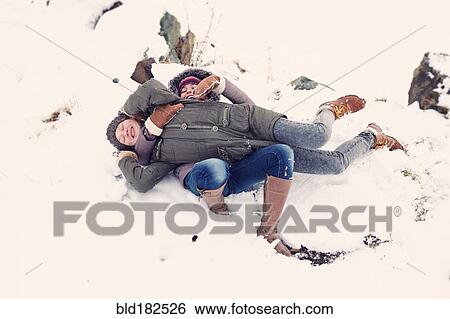 Stock Photograph - Caucasian teenage girls playing in snow. Fotosearch