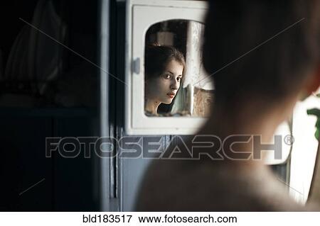 Caucasian woman admiring herself in mirror View Large Photo Image Stock Photo - Caucasian woman admiring herself in mirror. Fotosearch