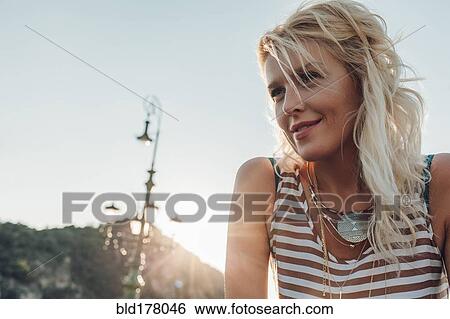 Stock Photograph - Caucasian woman against blue sky. Fotosearch