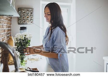Caucasian woman arranging flowers View Large Photo Image Stock Photo - Caucasian woman arranging flowers. Fotosearch