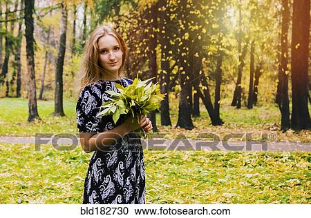 Caucasian woman carrying bouquet in park View Large Photo Image Stock Image - Caucasian woman carrying bouquet in park. Fotosearch