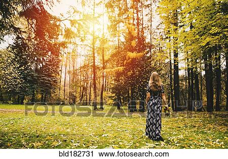 Caucasian woman carrying bouquet in park View Large Photo Image Stock Image - Caucasian woman carrying bouquet in park. Fotosearch