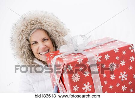 Caucasian woman carrying Christmas gifts View Large Photo Image Stock Image - Caucasian woman carrying Christmas gifts. Fotosearch