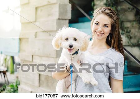 Caucasian woman carrying dog outdoors View Large Photo Image Stock Photo - Caucasian woman carrying dog outdoors. Fotosearch