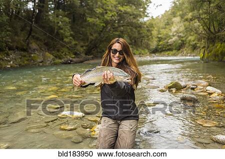 Caucasian woman catching fish in remote river View Large Photo Image Stock Image - Caucasian woman catching fish in remote river. Fotosearch