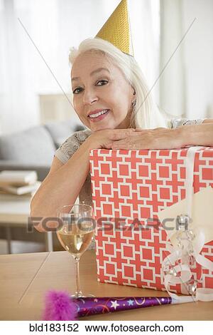 Stock Image - Caucasian woman celebrating birthday. Fotosearch